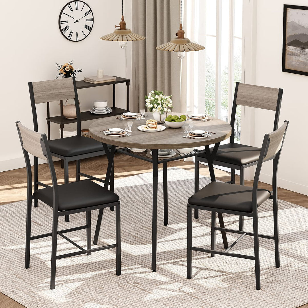 Dining room set with round table and chairs in a well-lit room.