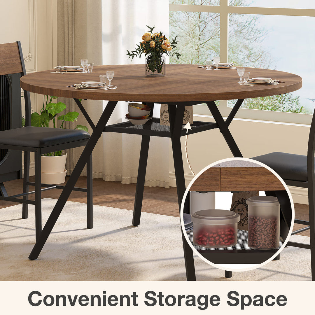 Round wooden dining table with black metal legs in a room with large windows.