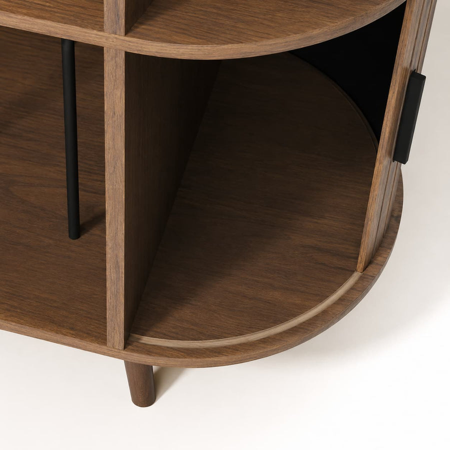 Close-up of a curved wooden cabinet or shelf unit with dark brown wood grain, black metal support legs, and a black handle on a white background.