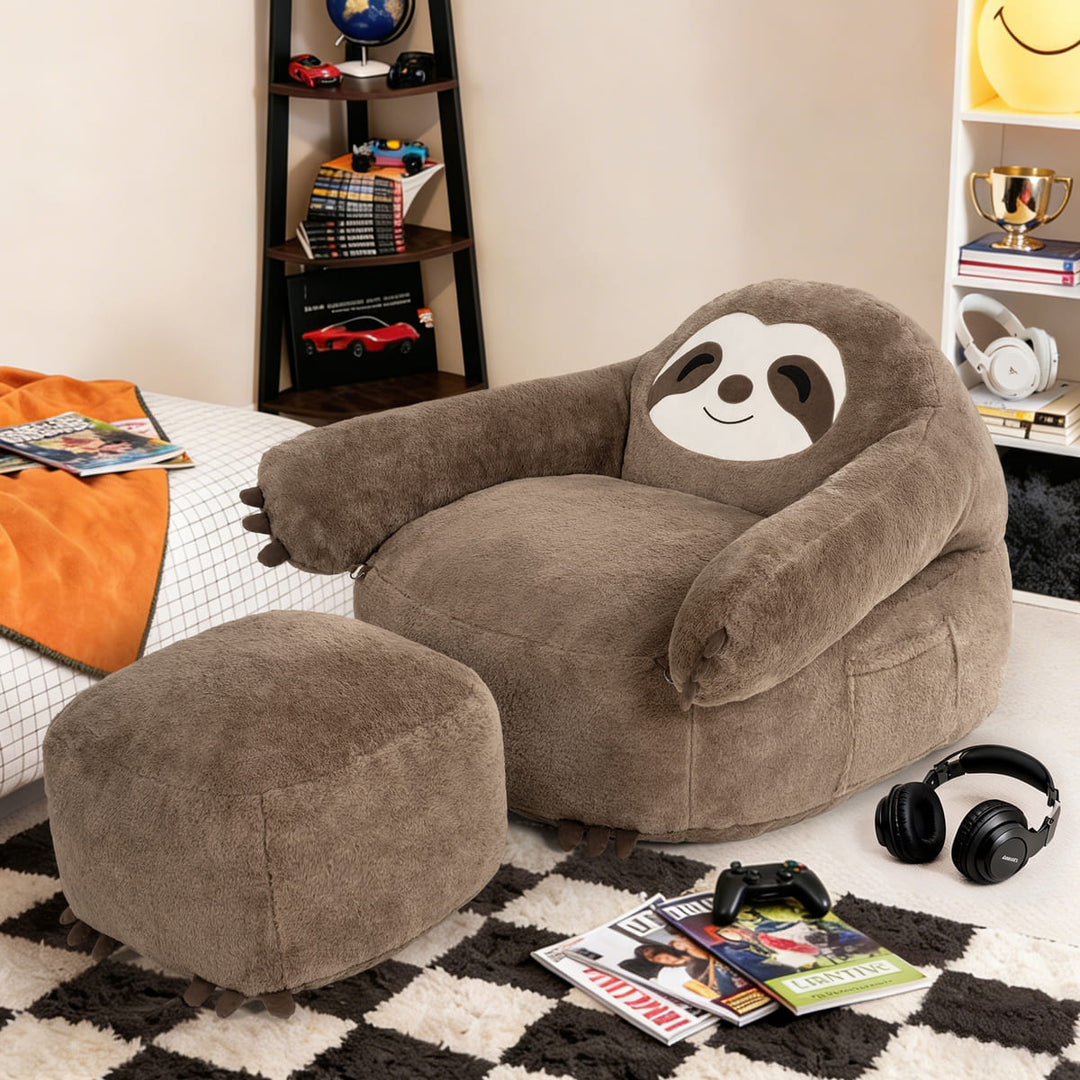 Sloth-shaped bean bag chair with ottoman in a room setting with books and headphones.
