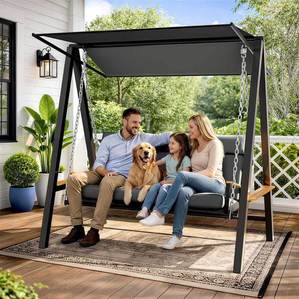 Family relaxing on the Pamapic Forge 3-seat patio swing with canopy