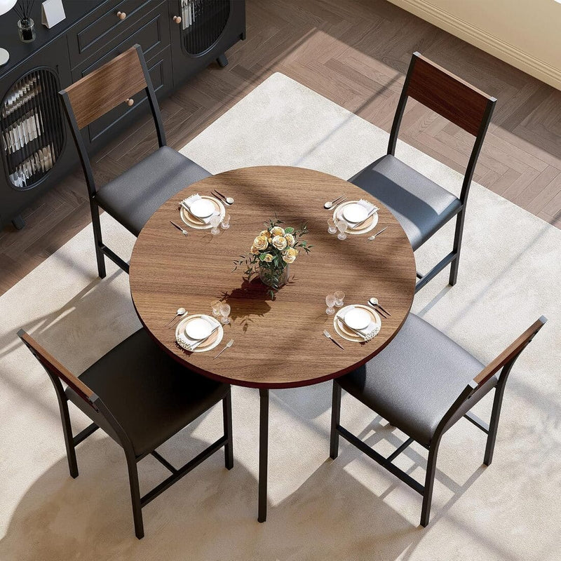 Round wooden dining table with four chairs in a room with a rug and cabinets.